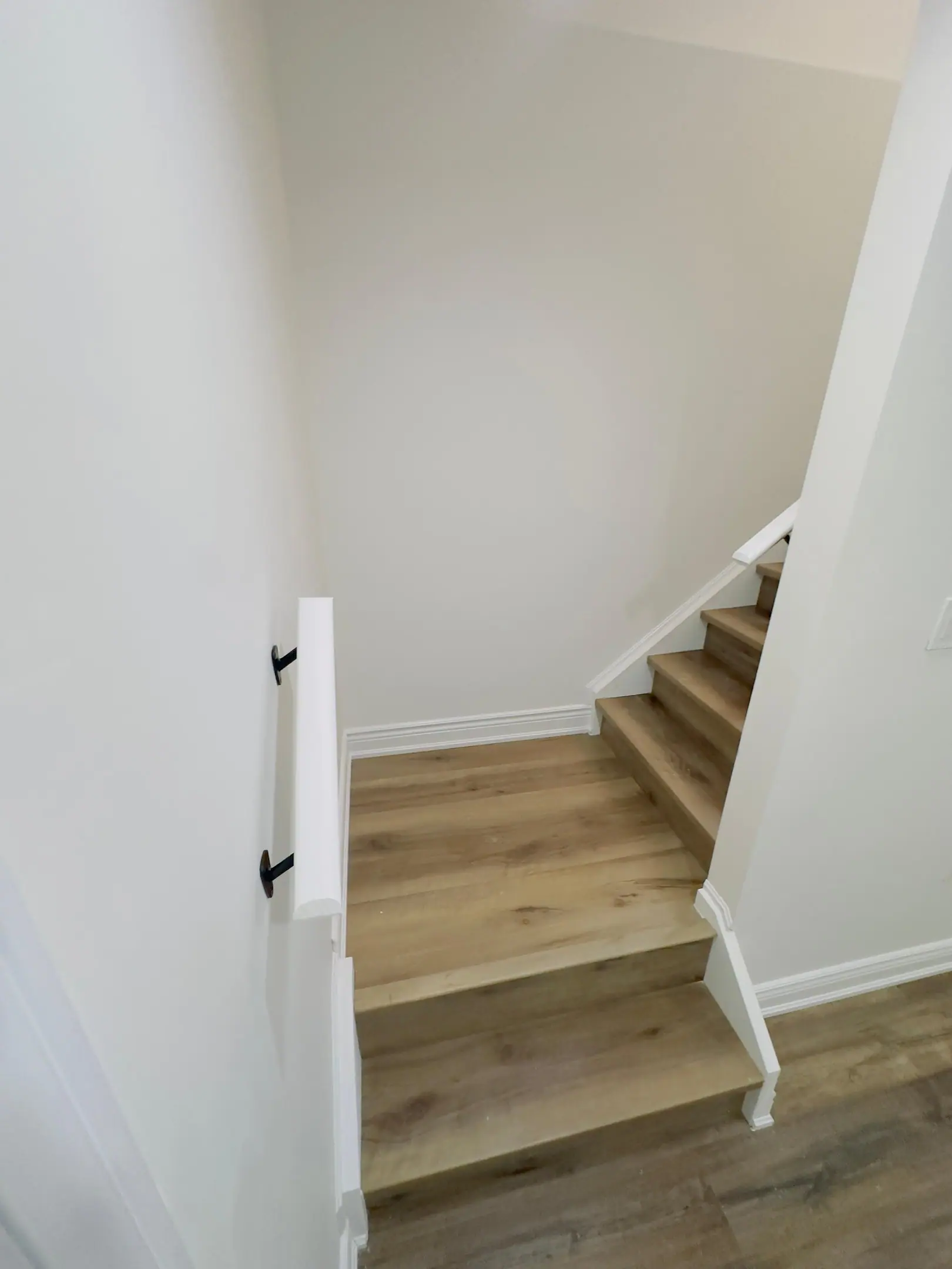 Basement stair landing with wood-look treads