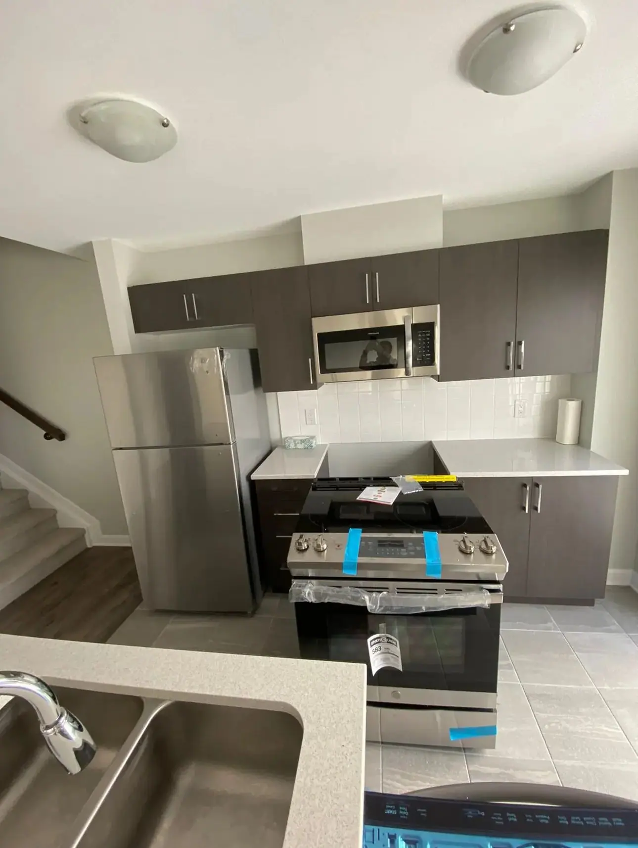 During construction: Basement suite kitchen under construction with new range and sink