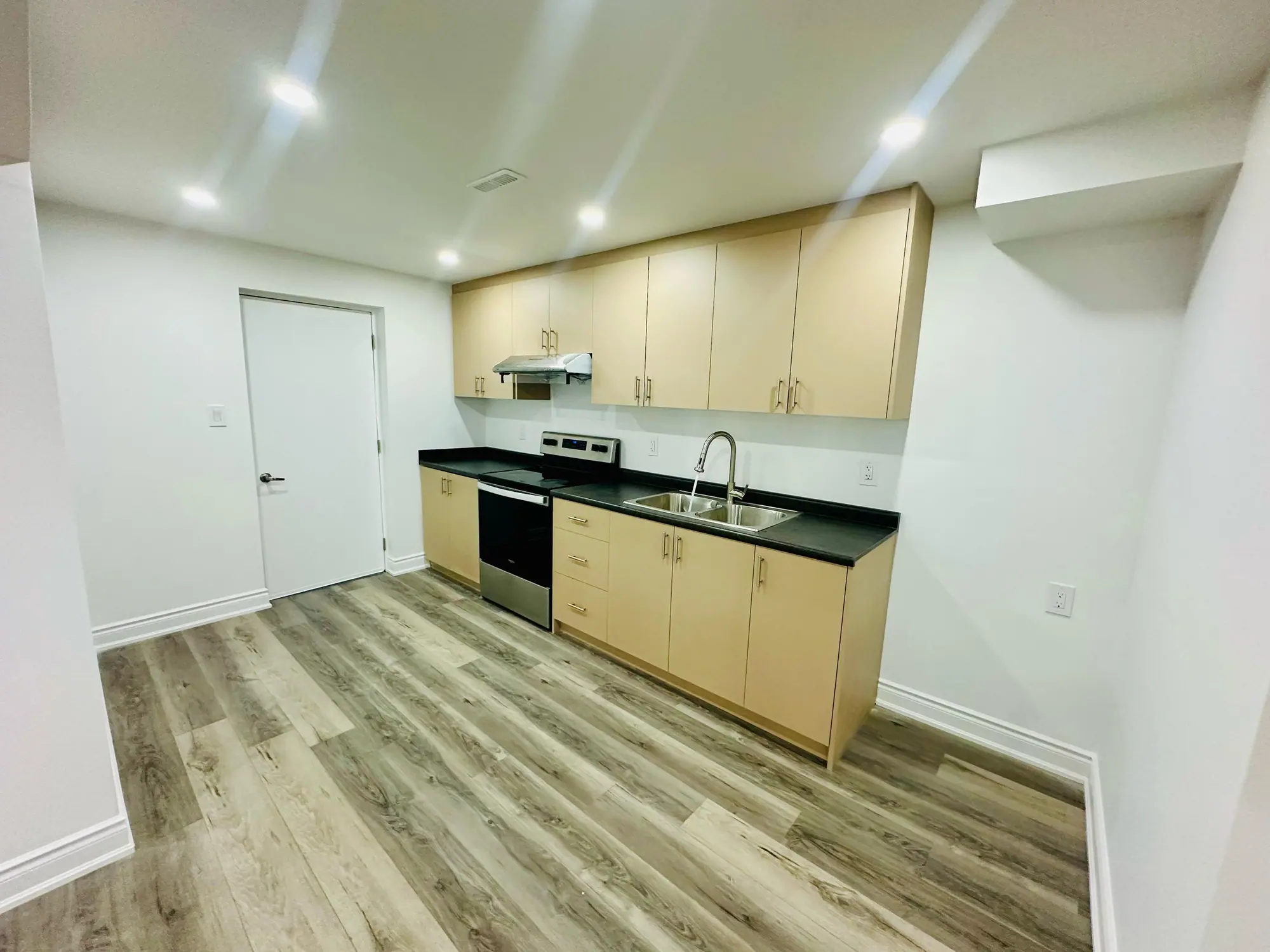 Finished: Legal basement apartment kitchen with maple cabinets and stainless range
