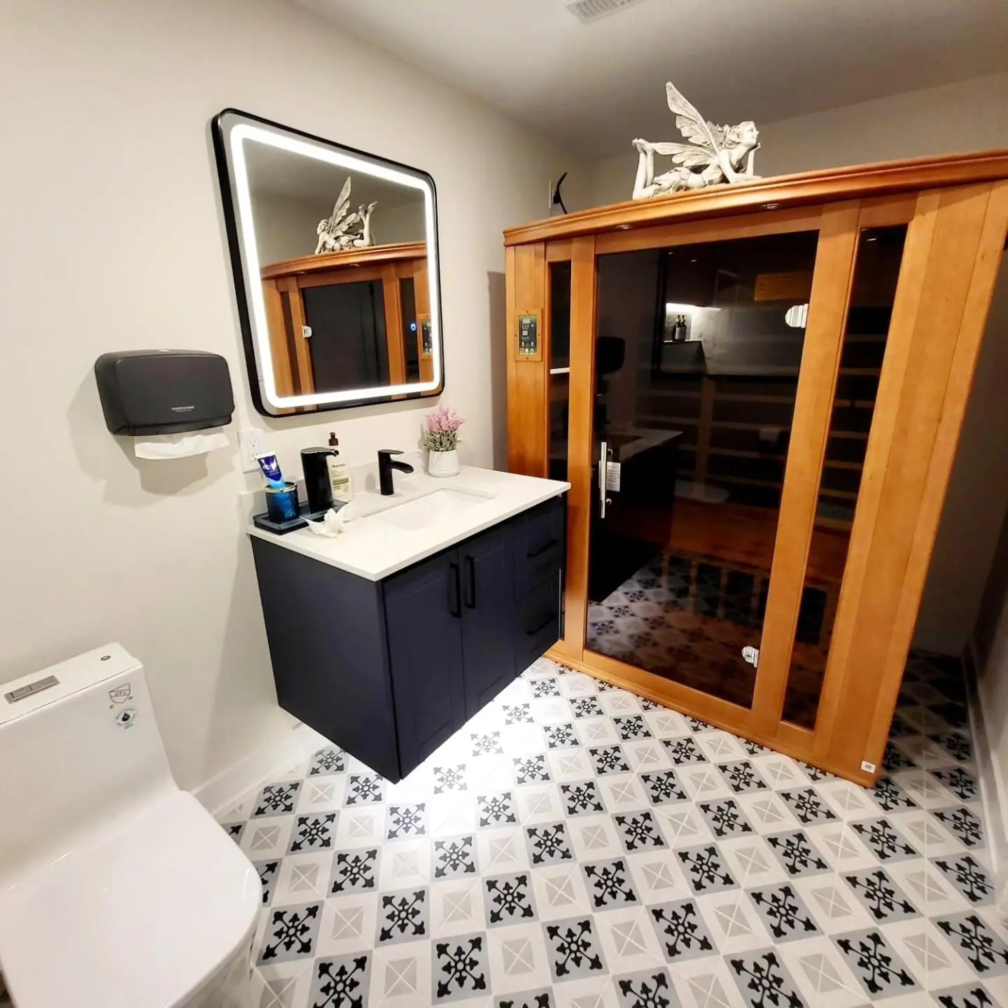 Bathroom with sauna, LED mirror and patterned tile floor