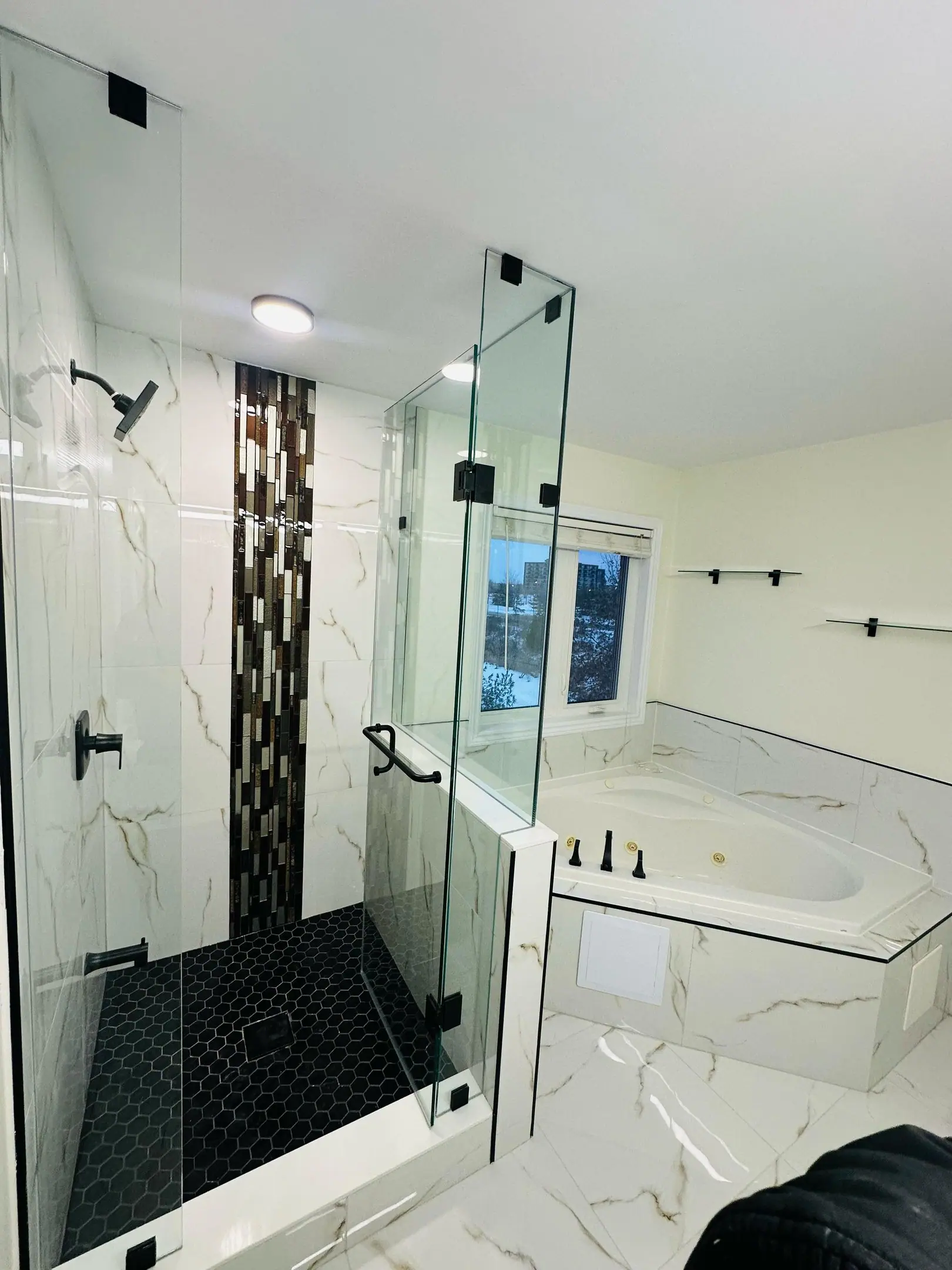 Ensuite with soaker tub, glass shower and mosaic accent