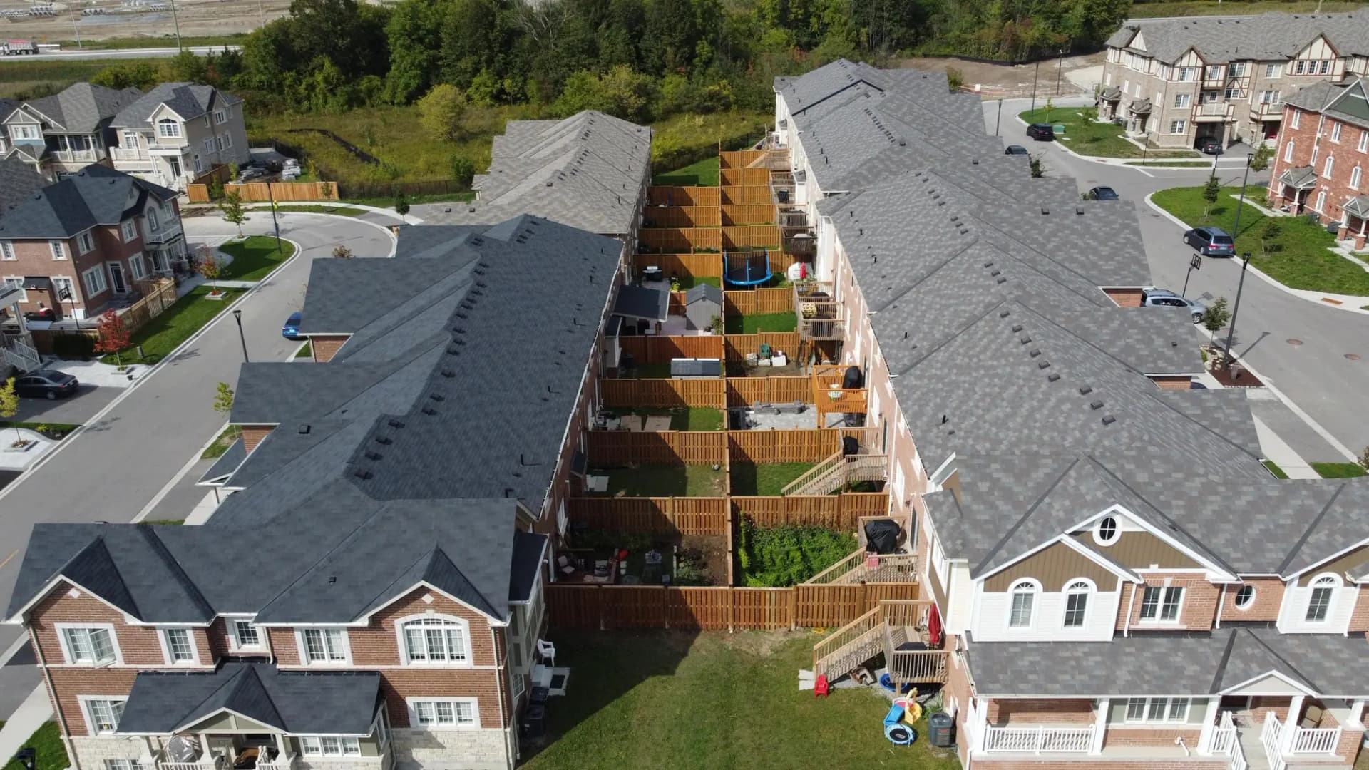 Aerial view of new wood privacy fences behind townhouses