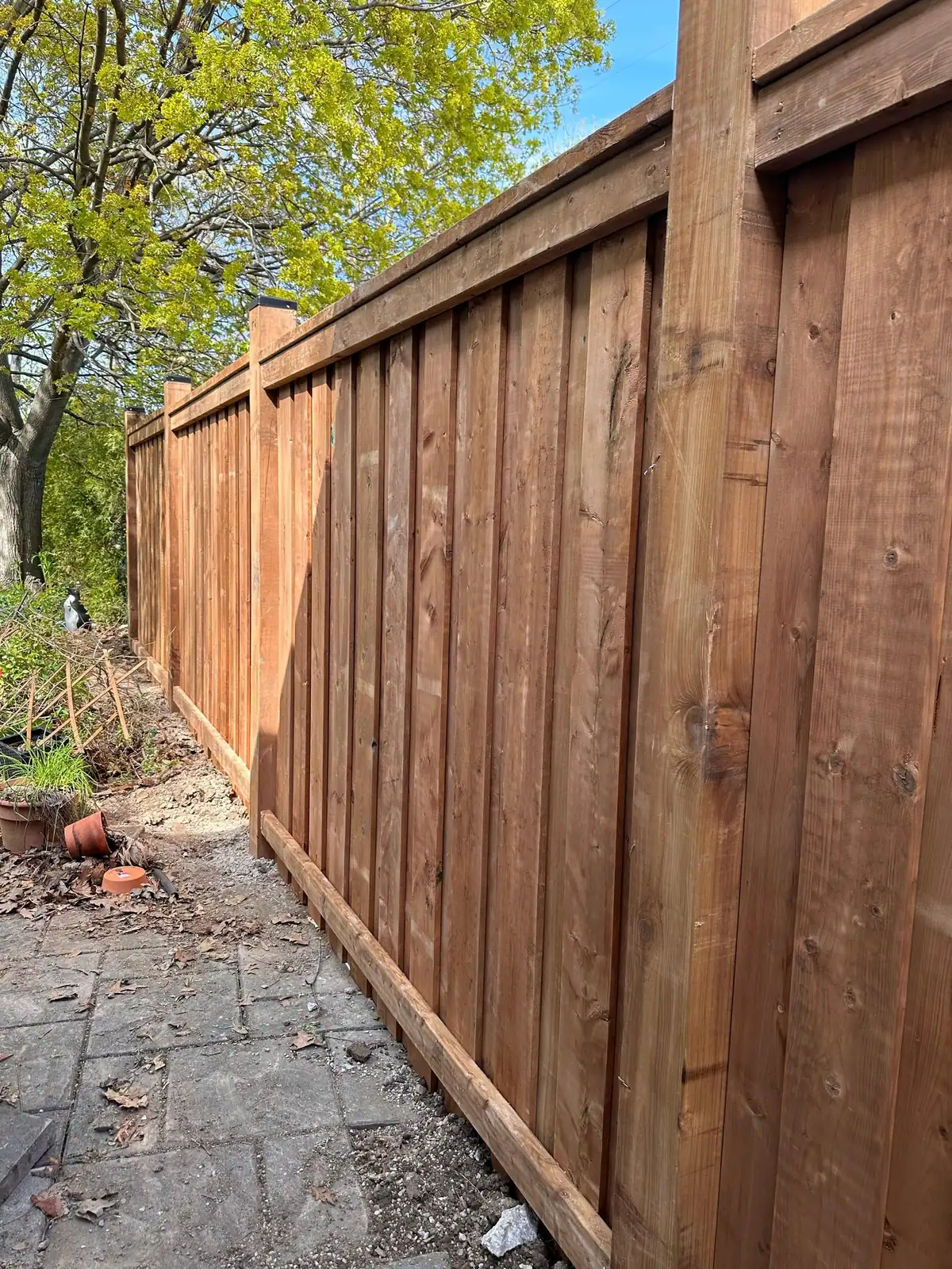 Tall wood privacy fence along a side yard