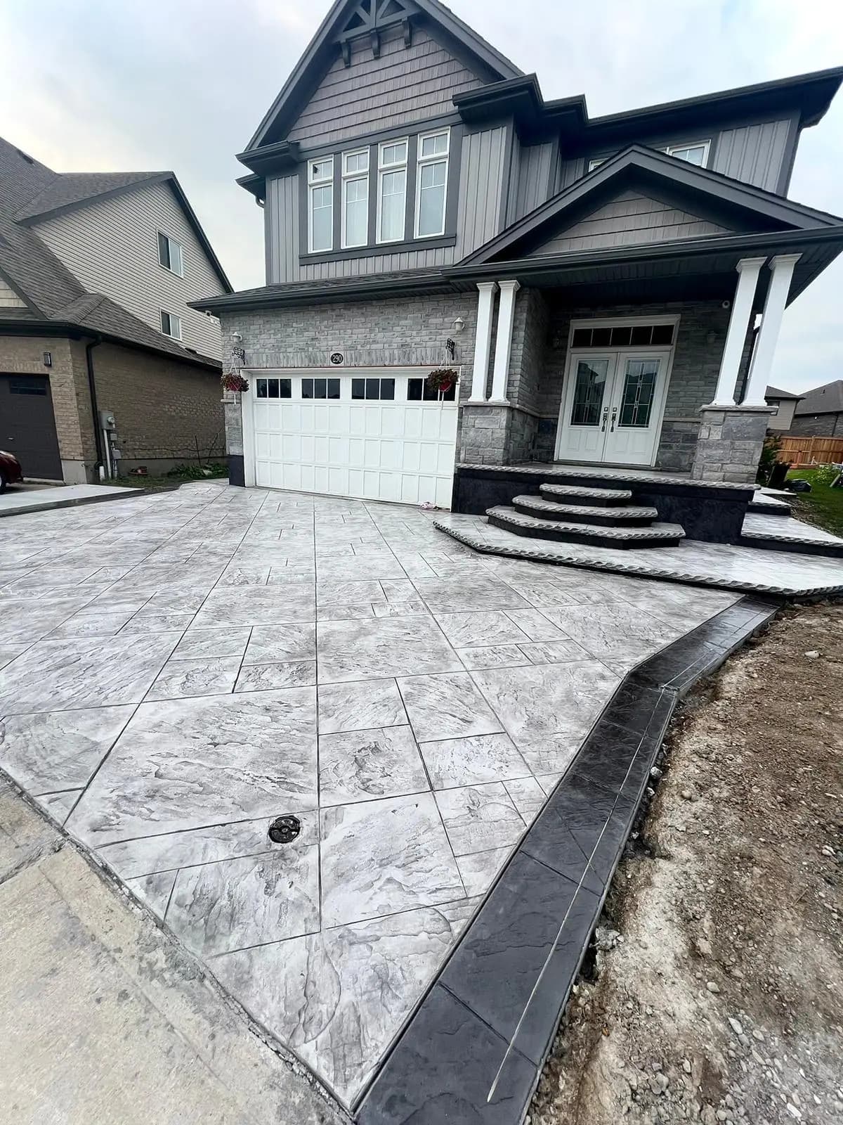 Stamped concrete driveway and steps at a new home