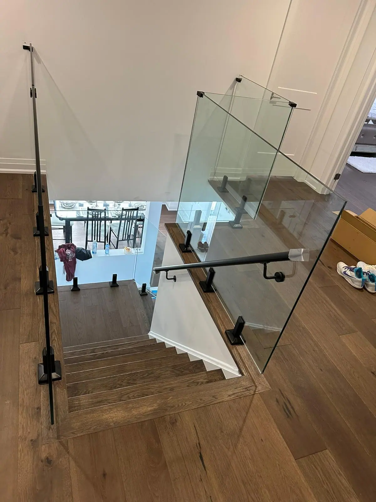 Staircase with frameless glass railing and oak treads