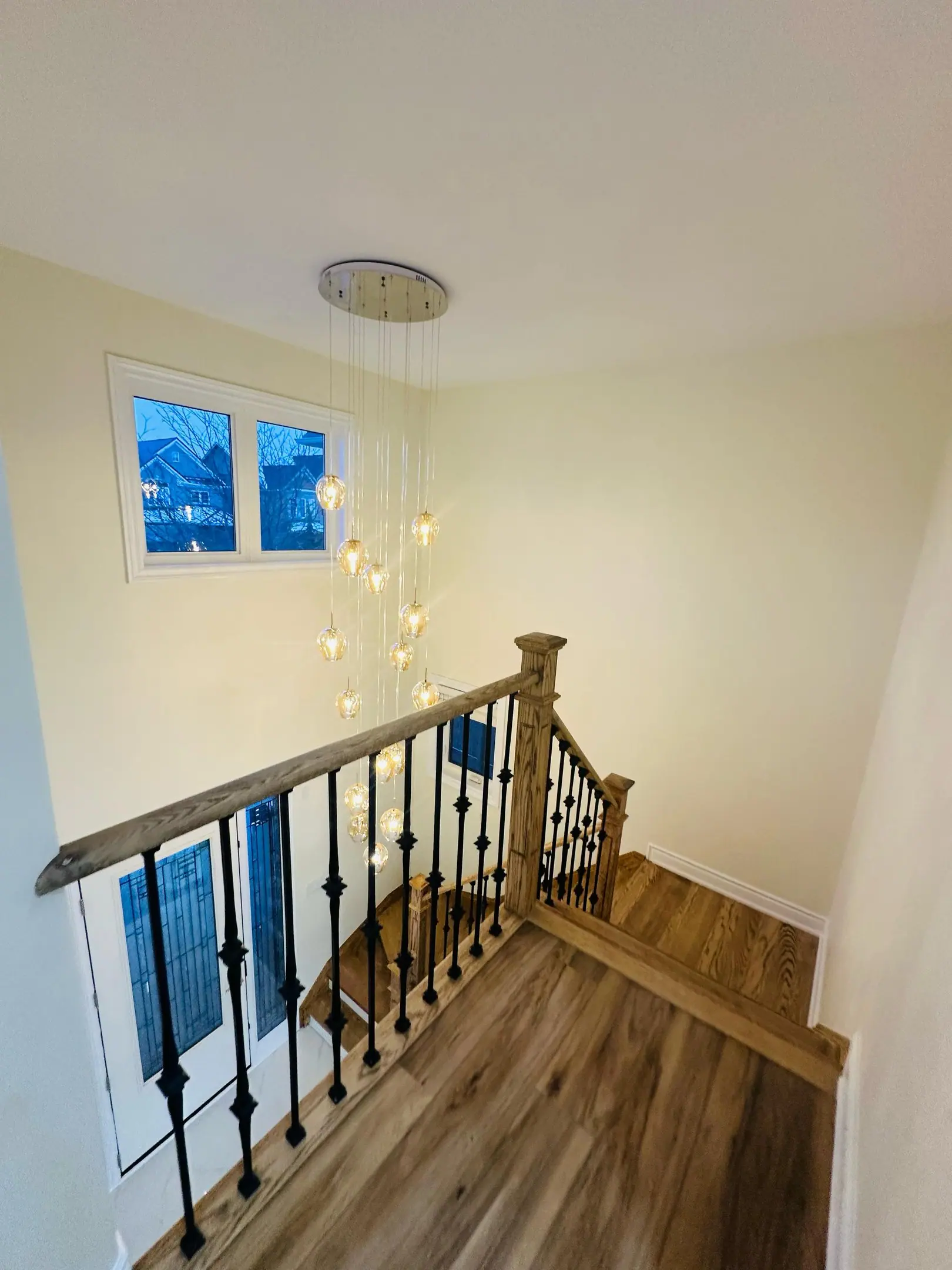 Upper landing with oak stair rail and iron balusters