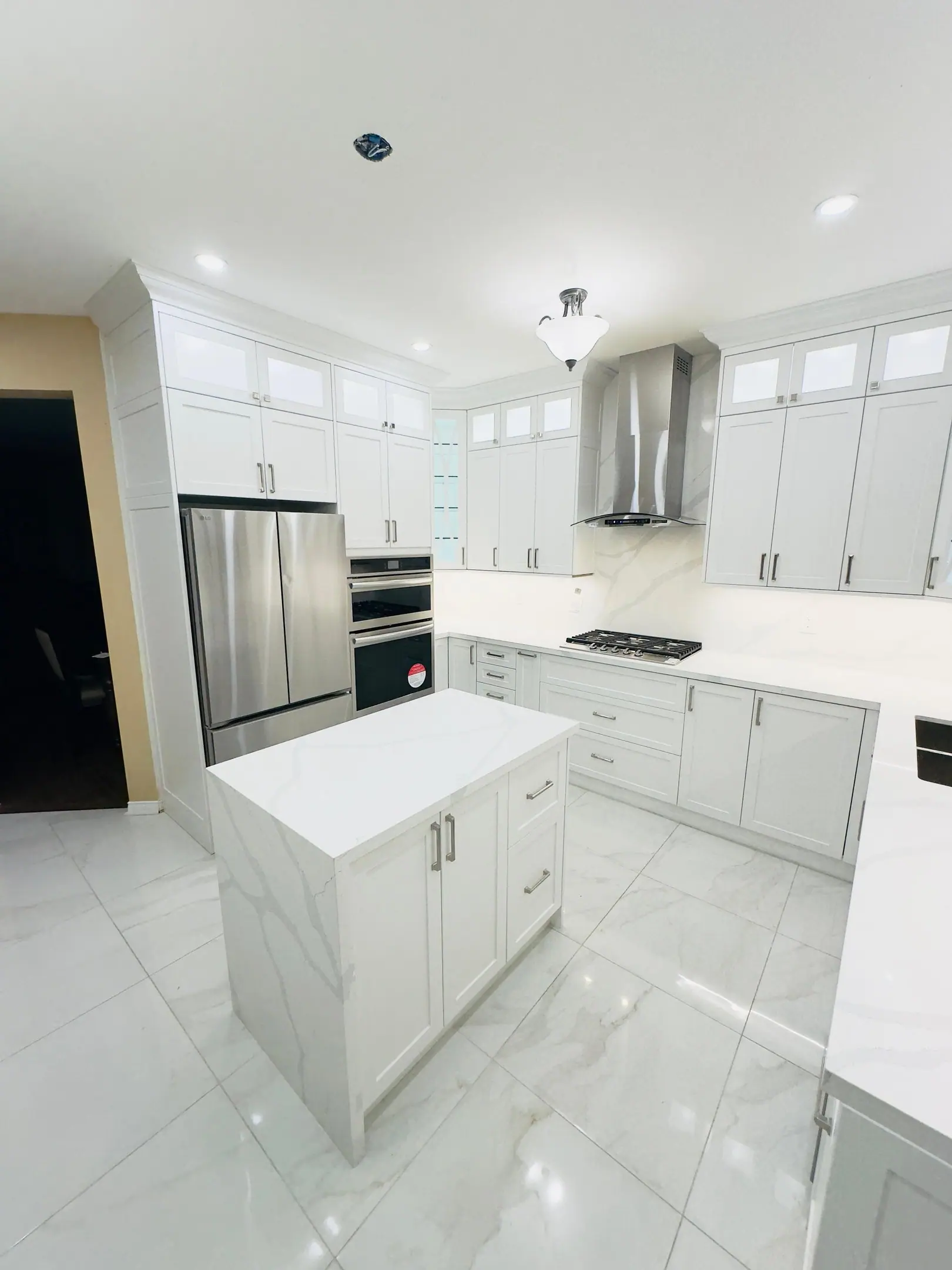 White kitchen with island and tall pantry cabinets
