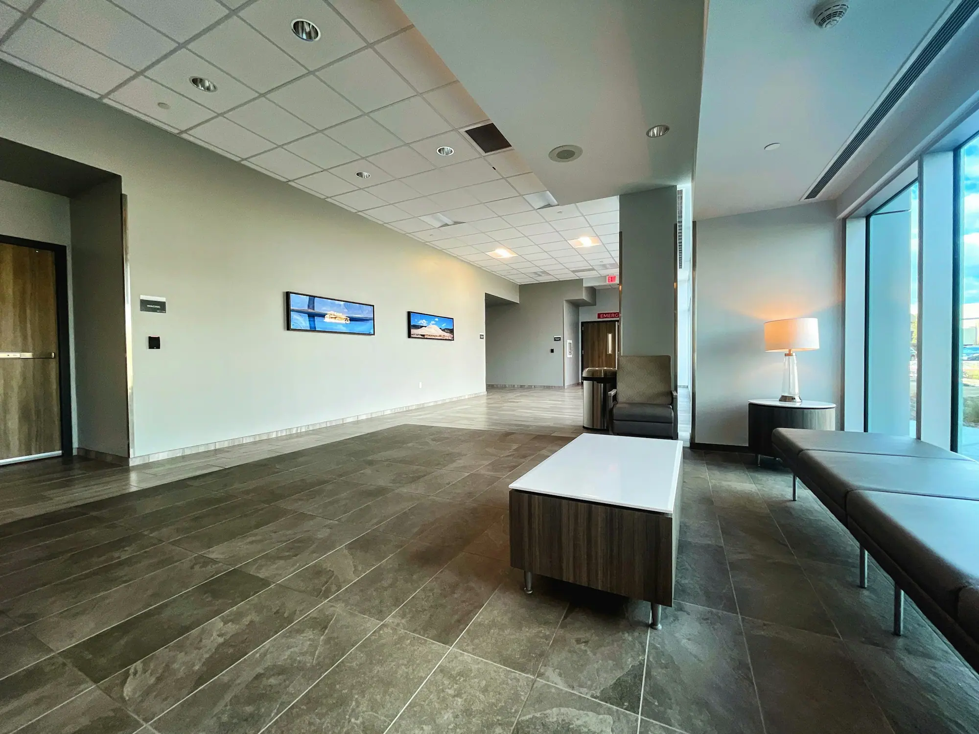 Clinic waiting area with seating and large windows