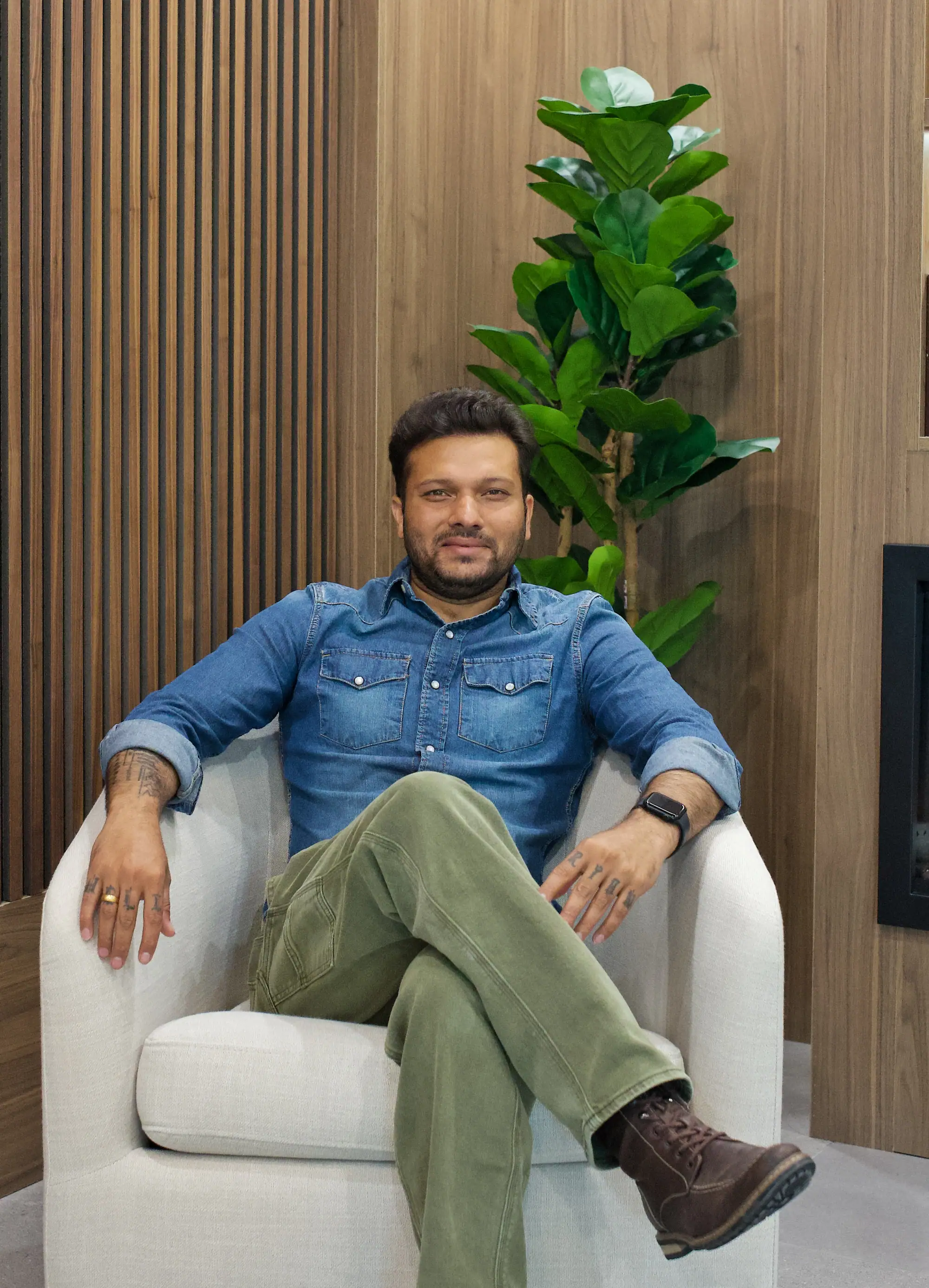 Monank Bhavsar, owner of CarpentryBoys Inc., seated in a walnut-panelled room